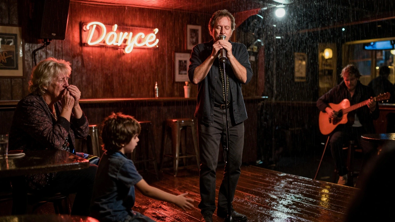 A bandleader plays a soulful solo as an elderly woman cries and a child reaches for the guitar on a rainy stage.